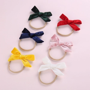 Detailed view of six soft velvet bow nylon headbands for babies in assorted colors