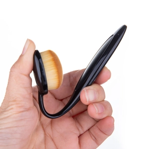 Ergonomic black toothbrush-shaped foundation brush with dense synthetic fibers