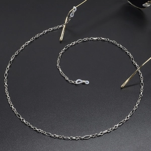 Silver metal eyeglass chain with round links and silicone anti-slip ends on grey background