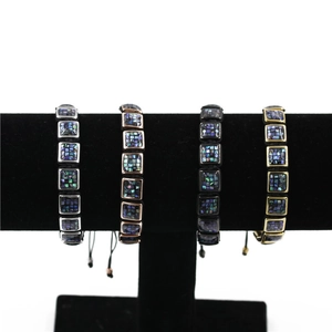 Detail of adjustable woven bracelets with colorful shell inlay in four metal finishes