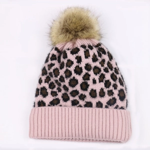 Pink leopard print knitted beanie for women featuring a fluffy faux fur pompom top