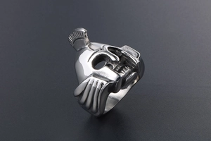 Close-up of vintage steel ring featuring a Spartan helmet and skull design in silver