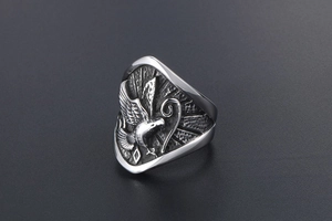 Vue rapprochée du relief d'aigle en argent sur bague en acier avec détails texturés