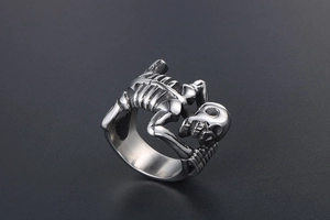 Detailed close-up of a silver titanium steel skull skeleton ring in punk hip-hop style