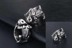 Detailed close-up of a vintage silver skull skeleton ring on a leather texture background