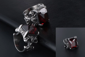 Detail shot of vintage silver steel ring featuring square red zircon and retro cross motifs