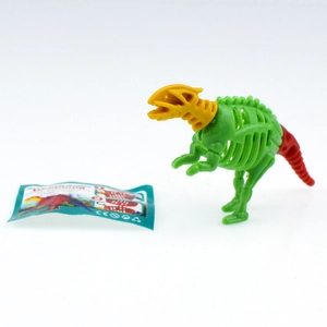 DIY dinosaur skeleton toy parts with assembly guide card on a plain white surface