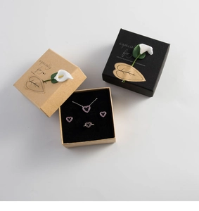 Jewelry set with heart-shaped necklace and ring in a kraft gift box with flower detail