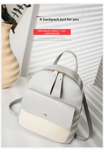 Detail of grey and beige contrast backpack with double zippers and metal buckle