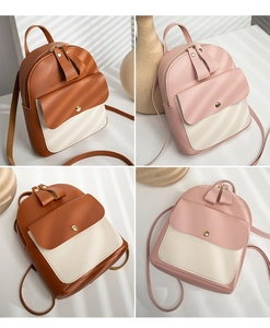 Detail view of mini PU leather backpacks in brown and pink colorblock designs with shadows