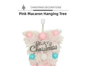 Detail of pink and blue macaron ornaments and Merry Christmas sign on upside-down tree