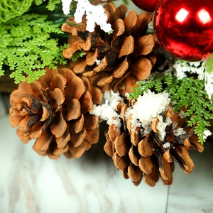 Christmas wreath with PE pine needles, snowy pine cones and festive red baubles