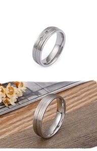 Detail view of frosted titanium couple rings with three circular zircon stone inlays