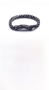 Macro view of vintage stainless steel braided wheat chain with a rectangle clasp detail