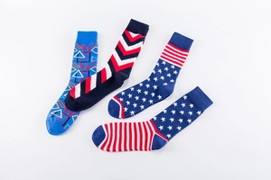 Detail of four colorful street-style crew socks with geometric and star patterns