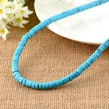 Close-up of blue cylindrical natural stone spacer beads for DIY jewelry making on linen