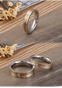 Macro detail of two-tone stainless steel couple rings with a centered small diamond
