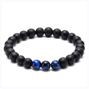Detail of natural blue tiger eye stones paired with matte black lava beads on a bracelet
