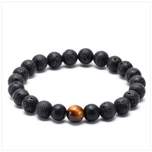 Detail view of tiger eye stone and matte lava beads on a beaded elastic bracelet