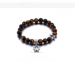 Detailed view of 8mm tiger eye beads with stainless steel hexagram and star charms