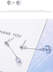 Detail view of 6mm square crystal drop earrings with polished silver metal finish
