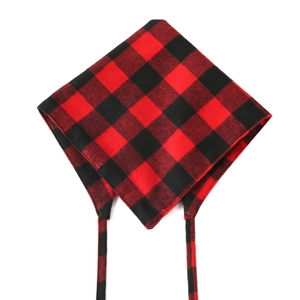 Detail view of red and black plaid cotton dog bandana with classic checkered pattern