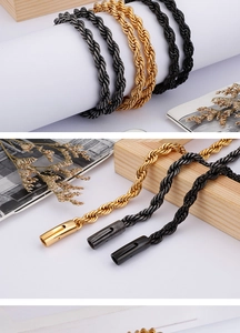 Detail of twisted rope chain bracelets in gold, black, and gunmetal grey finishes