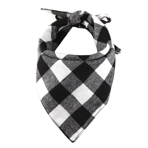 Close-up of black and white checkered cotton dog bandana with classic plaid texture