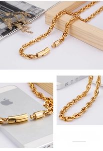 Macro view of gold stainless steel thick chain necklace with cylindrical lock buckle