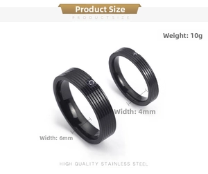 Detail of black titanium steel rings featuring brushed texture and inset small crystals