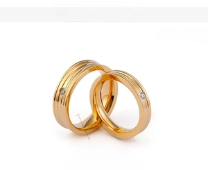 Close-up of 18K gold plated couple rings with sparkling round-cut zircon stones