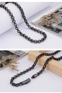 Detail of vintage stainless steel chain with Greek key patterns and secure magnetic clasp
