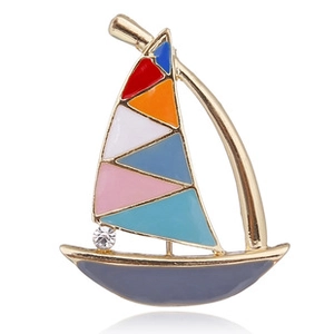 Detail of colorful enamel sailboat brooch with gold metal plating and crystal zircon