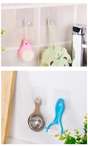 Transparent adhesive hooks shown hanging bathroom brushes and kitchen utensils on walls