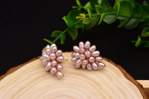 Macro shot of cluster lavender baroque pearl earrings on a natural wood block