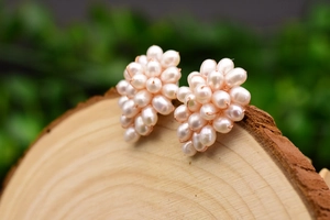 Macro detail of handmade pearl cluster earrings with elegant rose gold wire wrapping