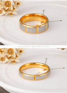 Detail view of two-tone stainless steel rings with gold plating and brushed silver finish