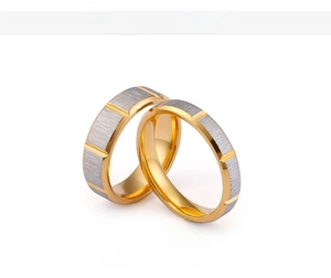 Detail view of 6mm and 4mm brushed stainless steel rings with 18K gold vacuum plating
