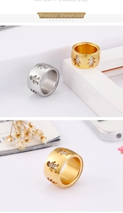 Detail of cutout boy and girl portraits on wide stainless steel rings with zircons