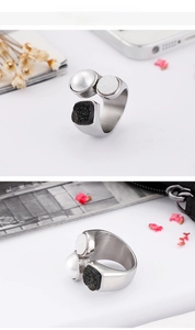 Macro detail of silver titanium steel ring featuring pearl and stone inlay accents