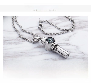 Detailed view of a 26g stainless steel whistle pendant with a built-in compass and rope chain
