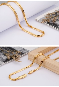 Detail of golden stainless steel rectangle link chain necklace with toggle clasp closure