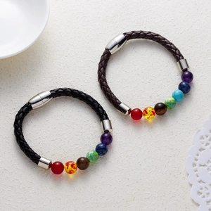 Detail view of woven leather bracelets with colorful chakra stone beads and magnetic clasp