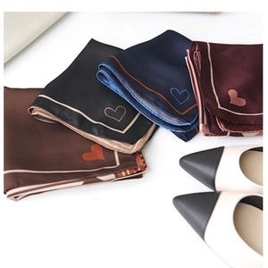 Detail of four silk scarves with heart embroidery and stripes in assorted colors