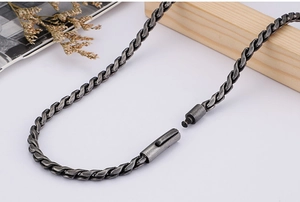 Close-up of dark grey antique silver twisted chain necklace with a barrel clasp detail