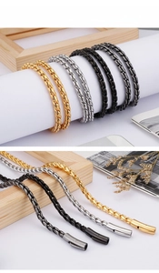 Detail view of woven metal chains in gold, silver, black, and gunmetal with plug-in clasps