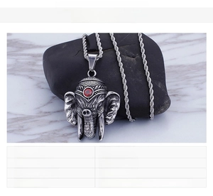 Detail of elephant head pendant with red gemstone and technical specs on stainless steel