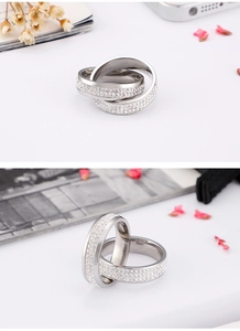 Detailed view of silver triple interlocking rings with pave-set white crystals