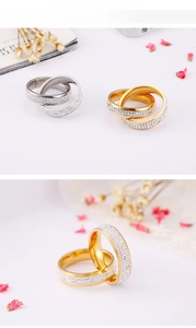 Detail showing gold and silver interlocking rings with pavé cubic zirconia inlay