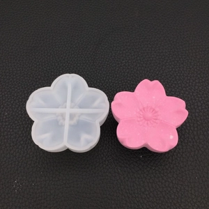 Detailed 3D cherry blossom silicone mold shown next to a finished pink flower craft